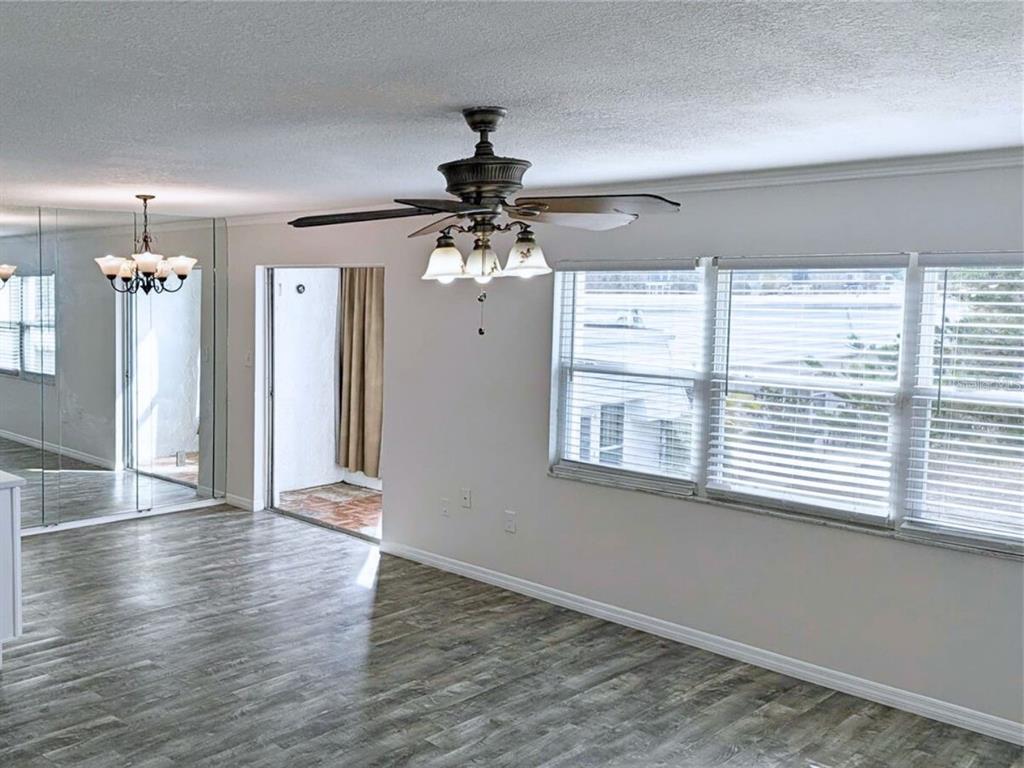 5434 Chad Place, Unit 14 New Port Richey, FL 34652 - Photo 5 of 13 a view of a livingroom with a window and wooden floor
