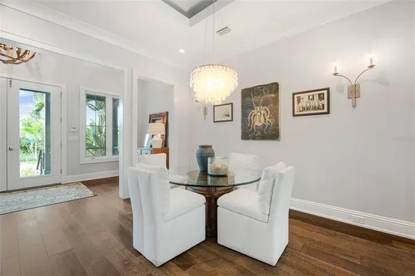 a living room with furniture ceiling fan and a large window