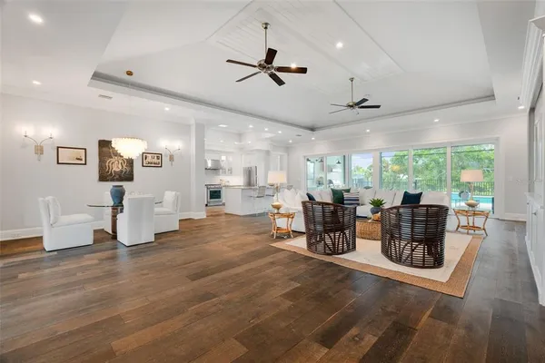 a dining hall with stainless steel appliances granite countertop a kitchen island a sink a refrigerator and a granite counter tops