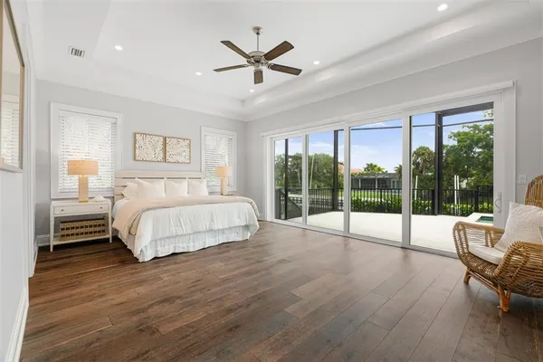 a bedroom with two beds and windows