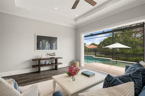 a living room with furniture and a floor to ceiling window