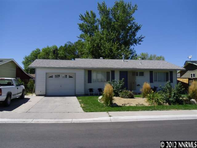 1225 Goldfield Street Reno, NV 89512 - Photo 1 of 1 a front view of a house with a yard and potted plants