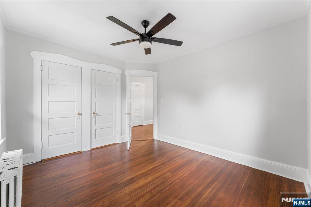 177 East Pierrepont Avenue Rutherford, NJ 07070 - Photo 23 of 27 an empty room with wooden floor and a ceiling fan
