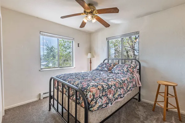 a bedroom with a bed window and a chandelier