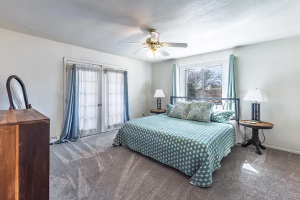 a bedroom with a bed wooden floor and window