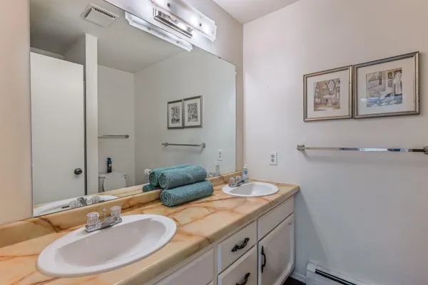 a bathroom with a granite countertop sink a mirror and a
