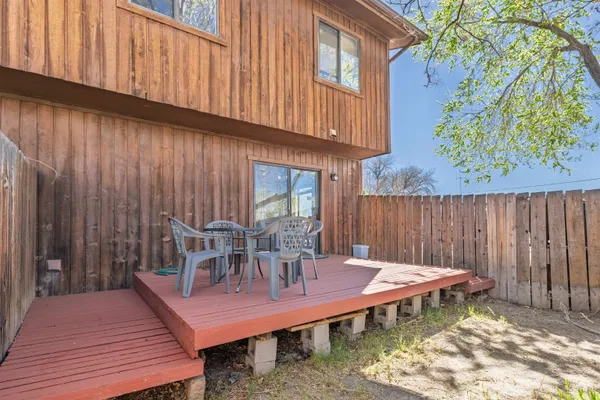 a view of a chairs and table in the patio
