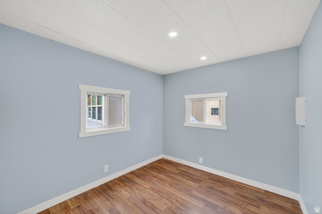 200 North Harrisville Road, Unit 37 Ogden, UT 84404 - Photo 12 of 14 Empty room with wood finished floors, plenty of natural light, and recessed lighting
