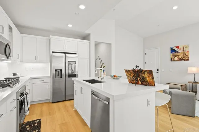 a kitchen with a sink and wooden floor