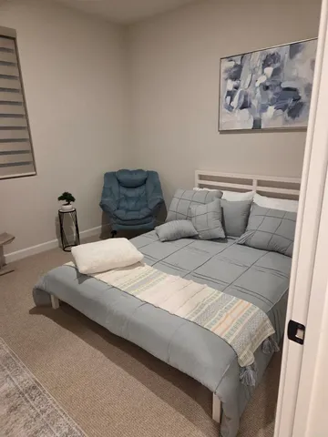 a bedroom with bed and wall painting