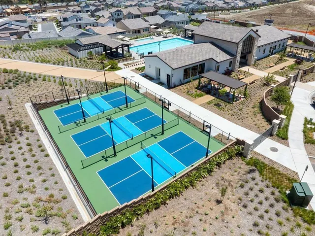 an aerial view of residential houses with outdoor space