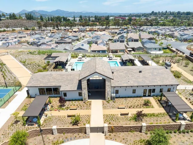 an aerial view of a house with a yard and parking space