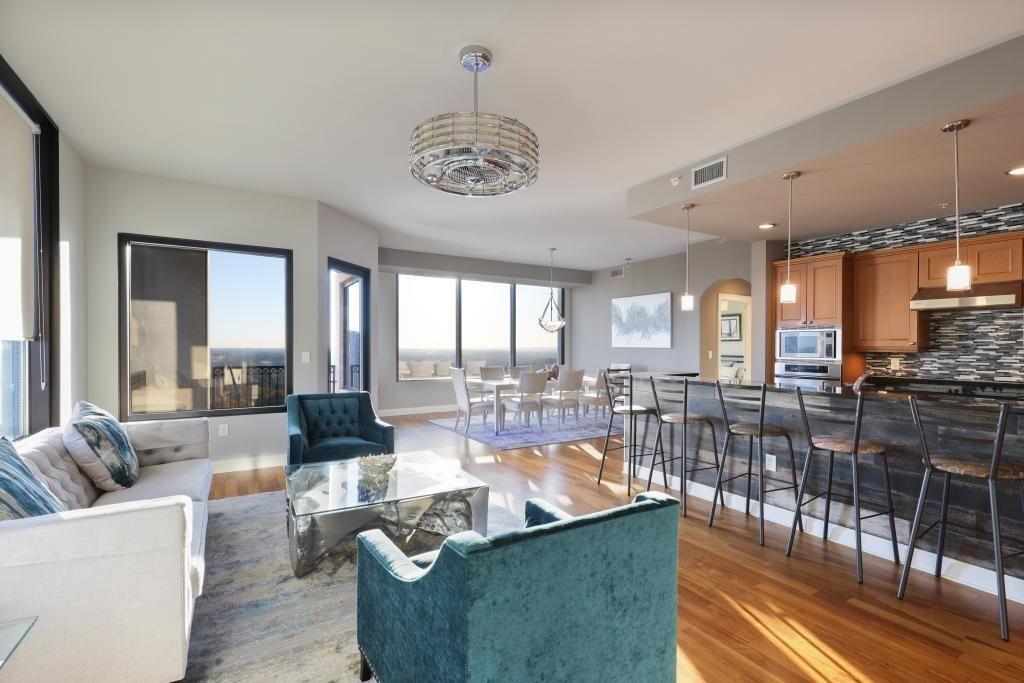 a living room with fireplace furniture and a large window