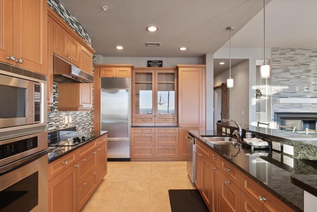 2828 Peachtree Road, Unit 2701 Atlanta, GA 30305 - Photo 13 of 39 a large kitchen with stainless steel appliances a large counter top a stove a sink and a refrigerator