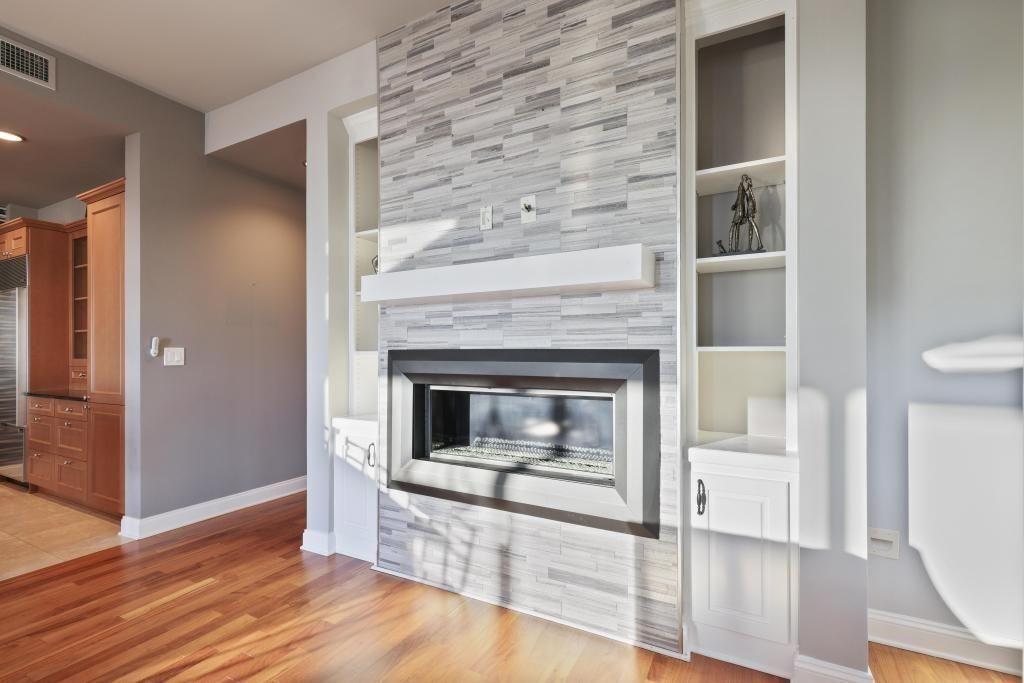 2828 Peachtree Road, Unit 2701 Atlanta, GA 30305 - Photo 19 of 39 a living room with a fireplace and wooden floor