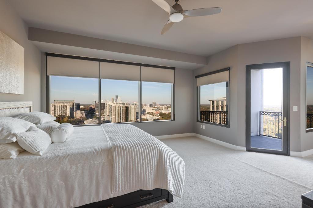 2828 Peachtree Road, Unit 2701 Atlanta, GA 30305 - Photo 20 of 39 a bedroom with a large bed and a large window