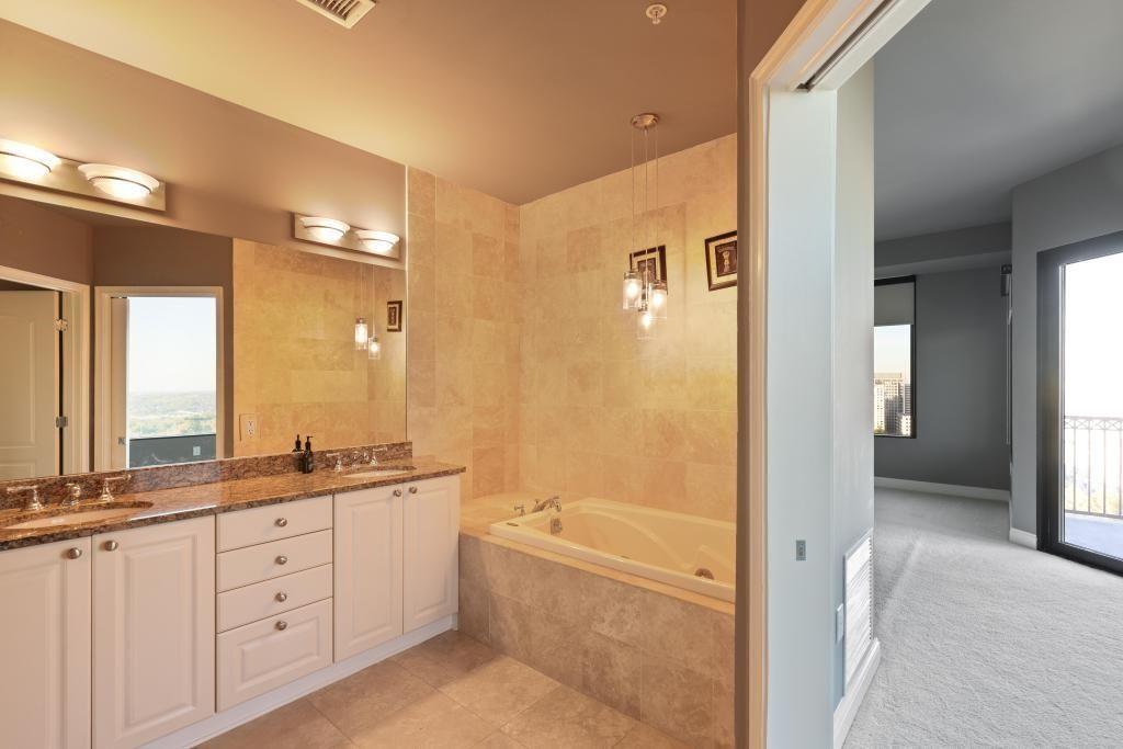 2828 Peachtree Road, Unit 2701 Atlanta, GA 30305 - Photo 22 of 39 a spacious bathroom with a granite countertop sink mirror and a bathtub