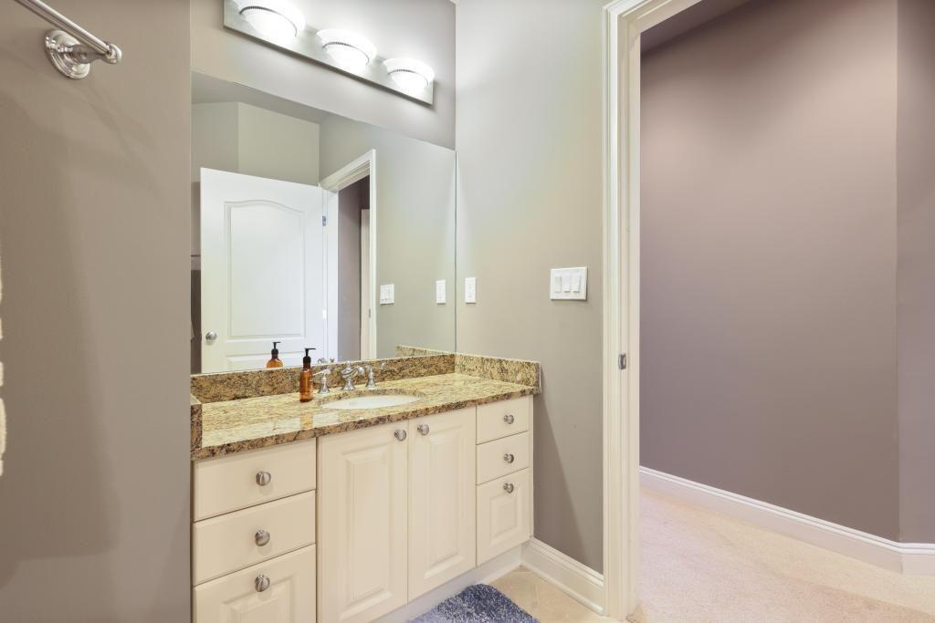 2828 Peachtree Road, Unit 2701 Atlanta, GA 30305 - Photo 26 of 39 a bathroom with a granite countertop sink and a mirror