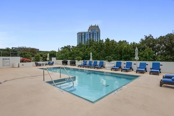 a view of a swimming pool with lawn chairs
