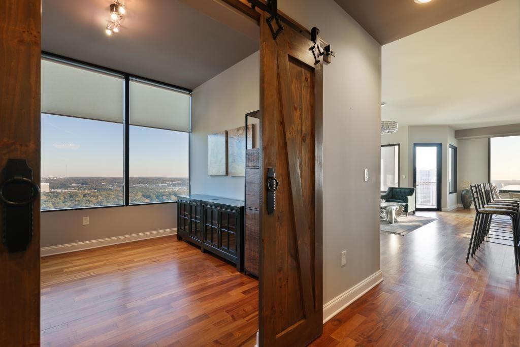 2828 Peachtree Road, Unit 2701 Atlanta, GA 30305 - Photo 4 of 39 an empty room with wooden floor and windows