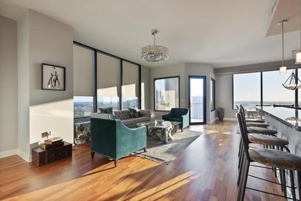 a living room with fireplace furniture and a large window