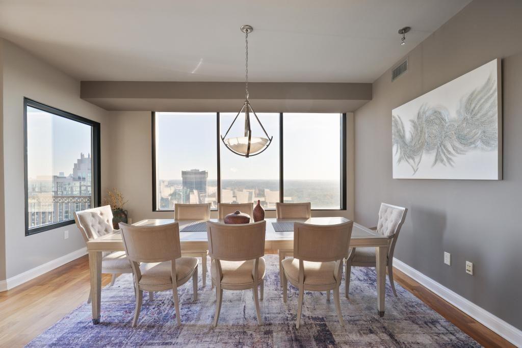 2828 Peachtree Road, Unit 2701 Atlanta, GA 30305 - Photo 9 of 39 a dining room with furniture a chandelier and wooden floor