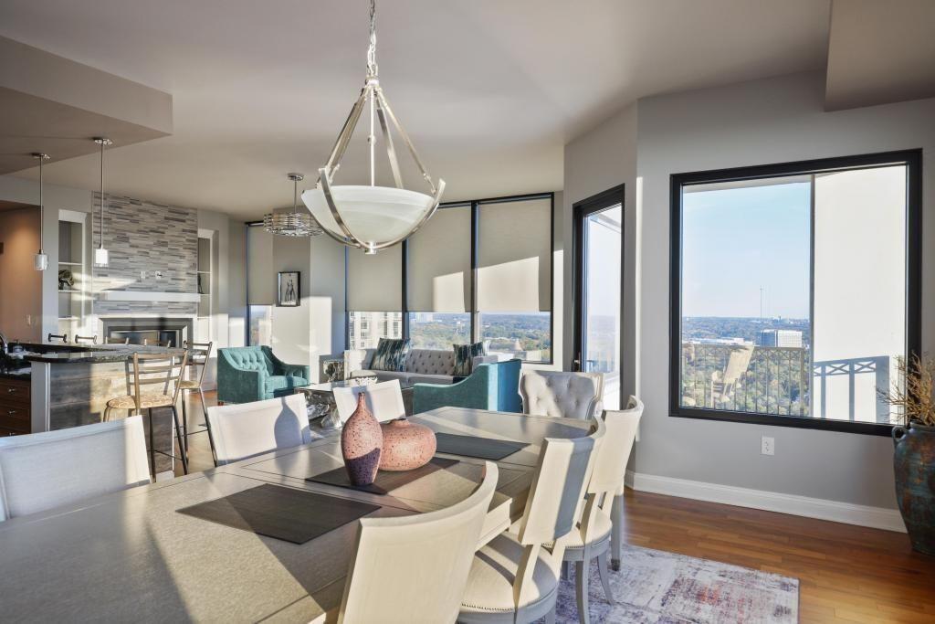 2828 Peachtree Road, Unit 2701 Atlanta, GA 30305 - Photo 10 of 39 a dining room with wooden floor a chandelier a glass table and chairs