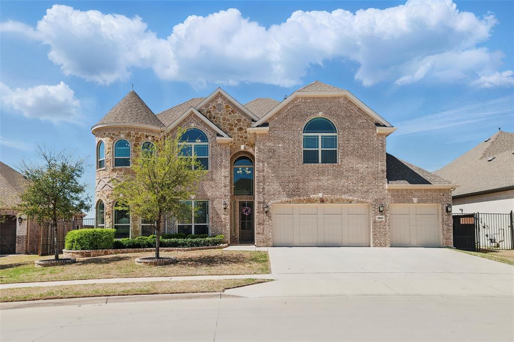9845 La Frontera Drive Fort Worth, TX 76179 - Photo 1 of 35 View of front of home with castle turret, three-car garage, fence, a gate, and brick siding