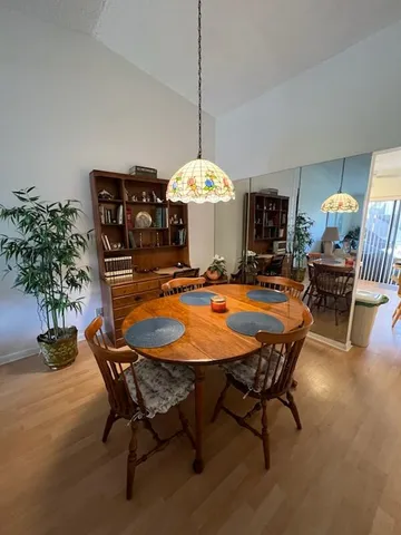 a dining room with furniture and wooden floor