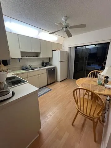 a kitchen with stainless steel appliances granite countertop a sink a stove and a refrigerator