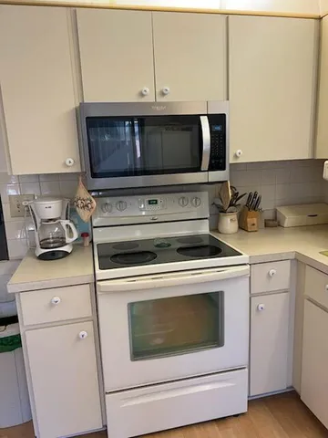 a kitchen with a stove and a microwave