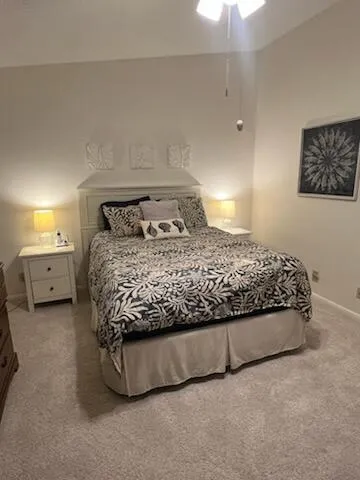 a bedroom with a bed and a night stand