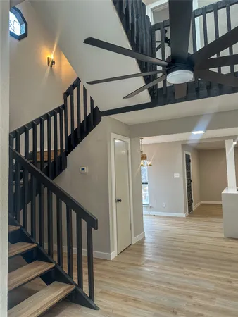a view of entryway and hall with wooden floor