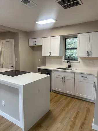 a kitchen with a sink cabinets and window
