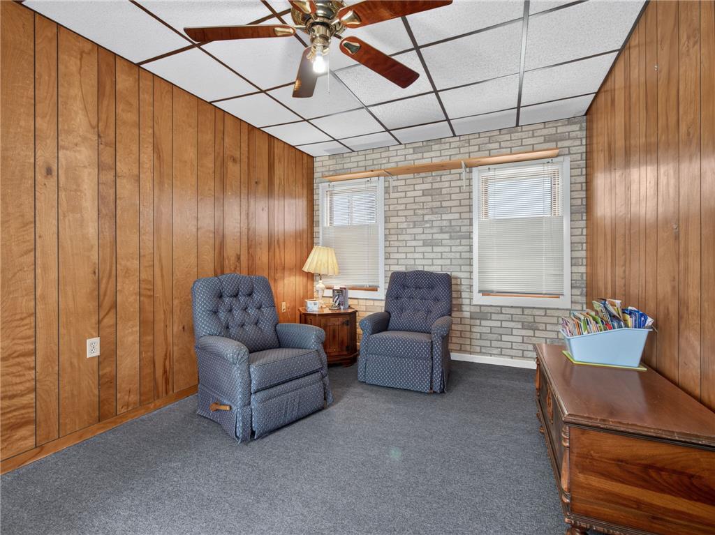 3046 Ridon Court Bethlehem, PA 18020 - Photo 28 of 41 A cozy, sun-filled den features wood paneling and a drop ceiling with a central fan.