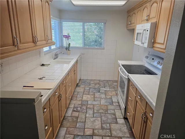a bathroom with a sink a vanity and a window