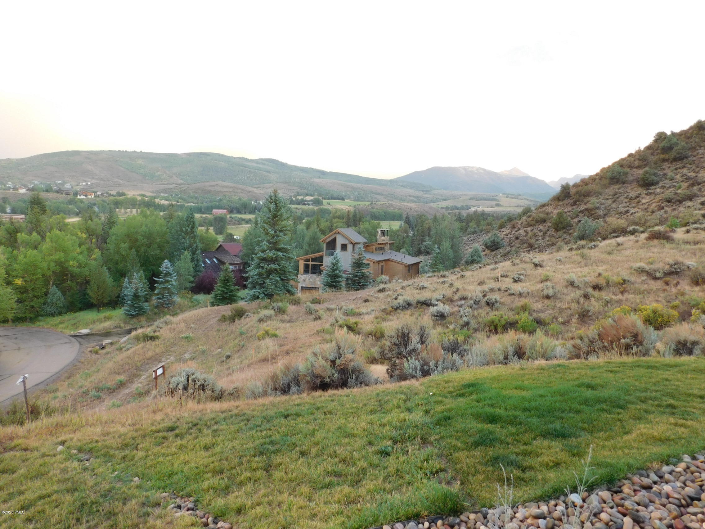 326 Brett Trail Edwards, CO 81632 - Photo 3 of 20 a view of a dry yard with mountain and trees