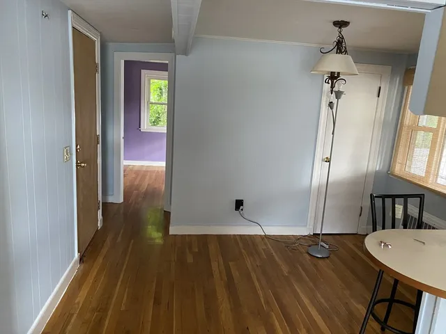 a view of a hallway view with wooden floor and staircase
