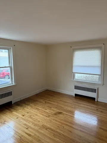 a view of an empty room and wooden floor