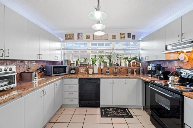 a kitchen with stainless steel appliances a sink and a stove