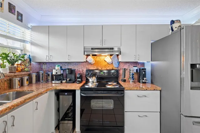 a kitchen with a sink stove and cabinets