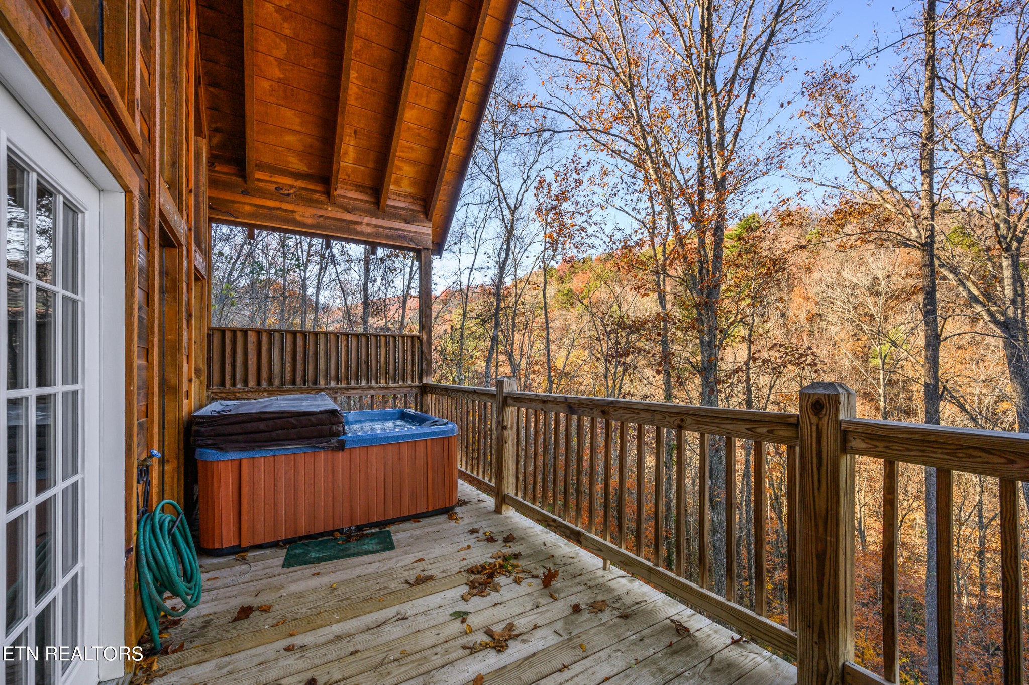 2505 Wildcat Ridge Road Sevierville, TN 37862 - Photo 19 of 48 a view of a wooden deck with a bench and wooden fence