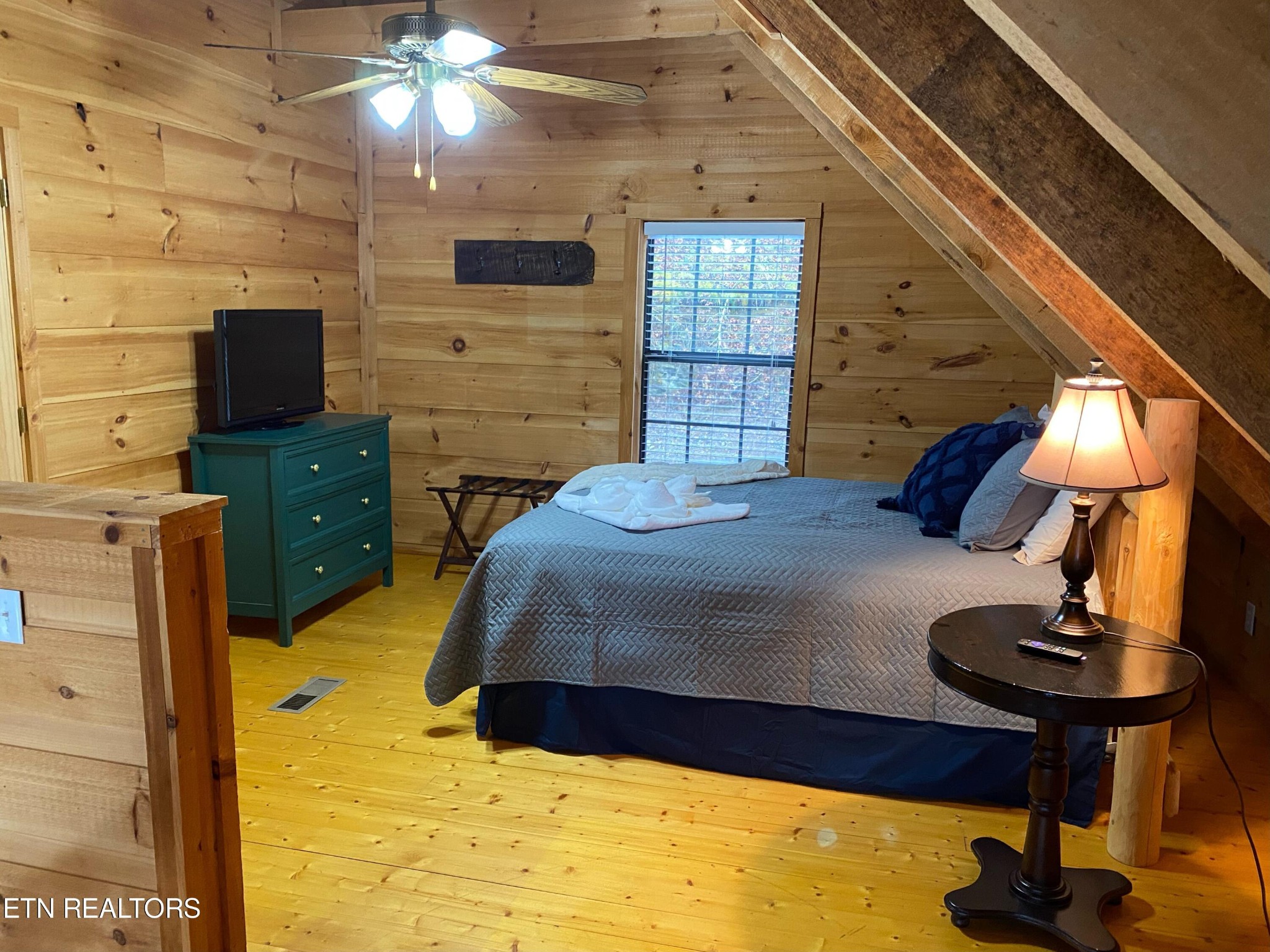 2505 Wildcat Ridge Road Sevierville, TN 37862 - Photo 24 of 48 a bedroom with a bed and a chandelier