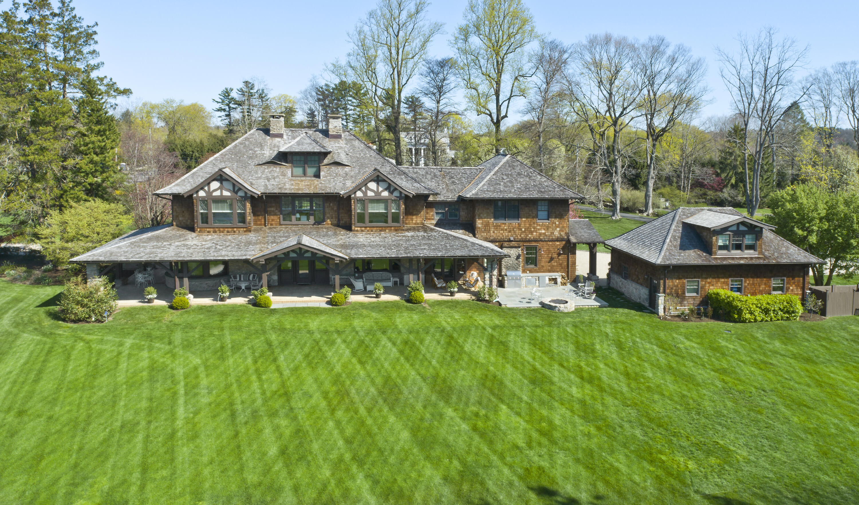 255 Brushy Ridge Road New Canaan, CT 06840 - Photo 2 of 40 a aerial view of a house with a big yard potted plants and large tree
