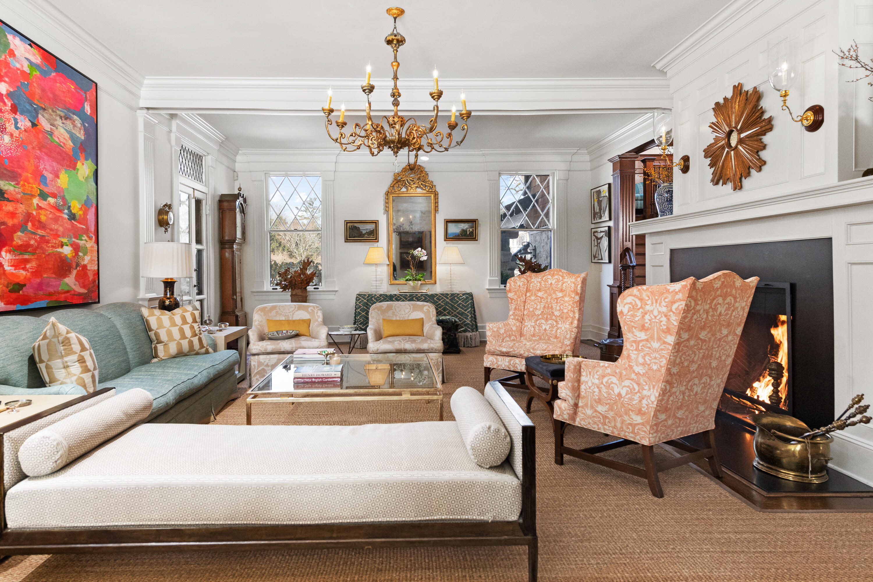 255 Brushy Ridge Road New Canaan, CT 06840 - Photo 25 of 40 a living room with fireplace furniture and a chandelier
