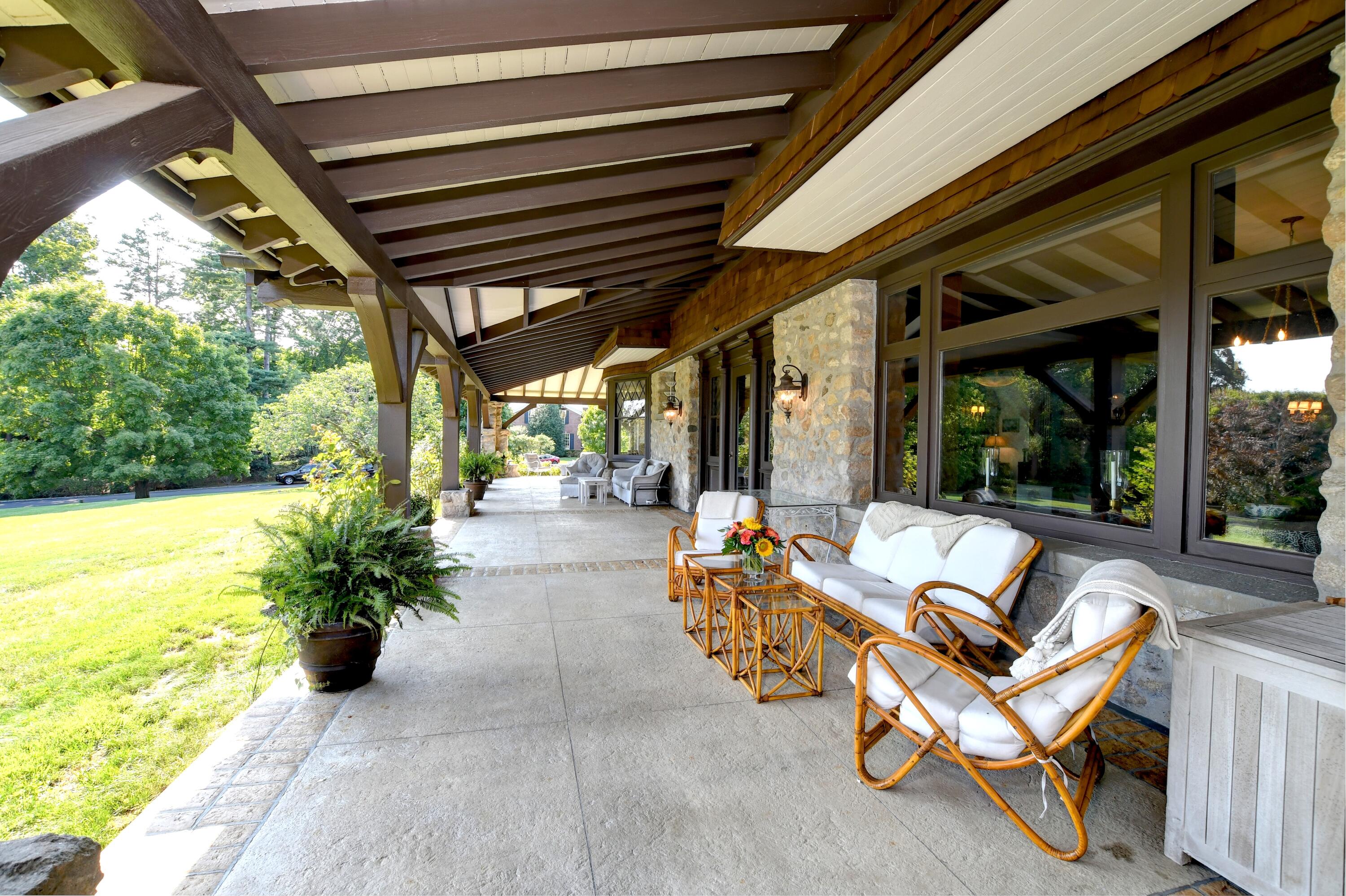 255 Brushy Ridge Road New Canaan, CT 06840 - Photo 6 of 40 a building outdoor space with patio furniture and potted plants