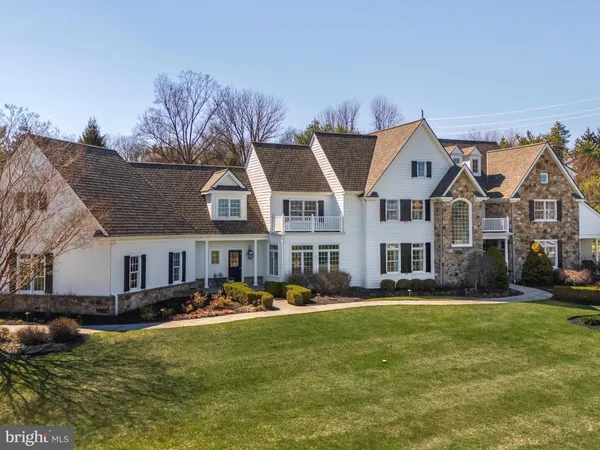 a front view of a house with a yard table and chairs