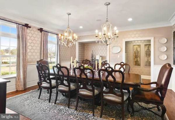 a view of a white house with a big yard and potted plants