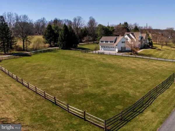a view of a pool with lawn chairs