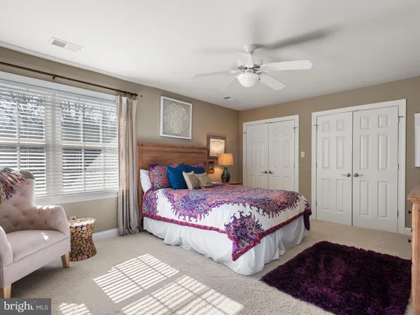 a view of a patio with table and chairs potted plants and a palm tree